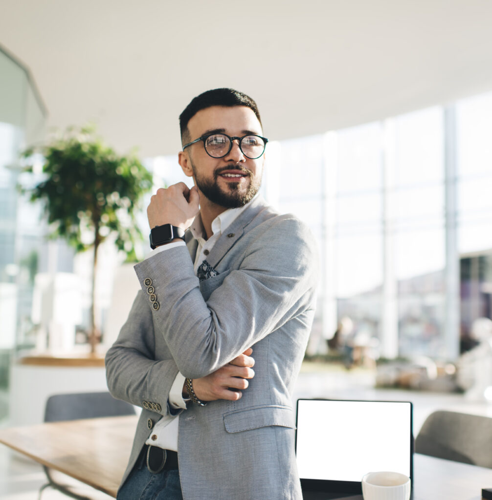 Smiling businessman in shirt and jacket in modern office